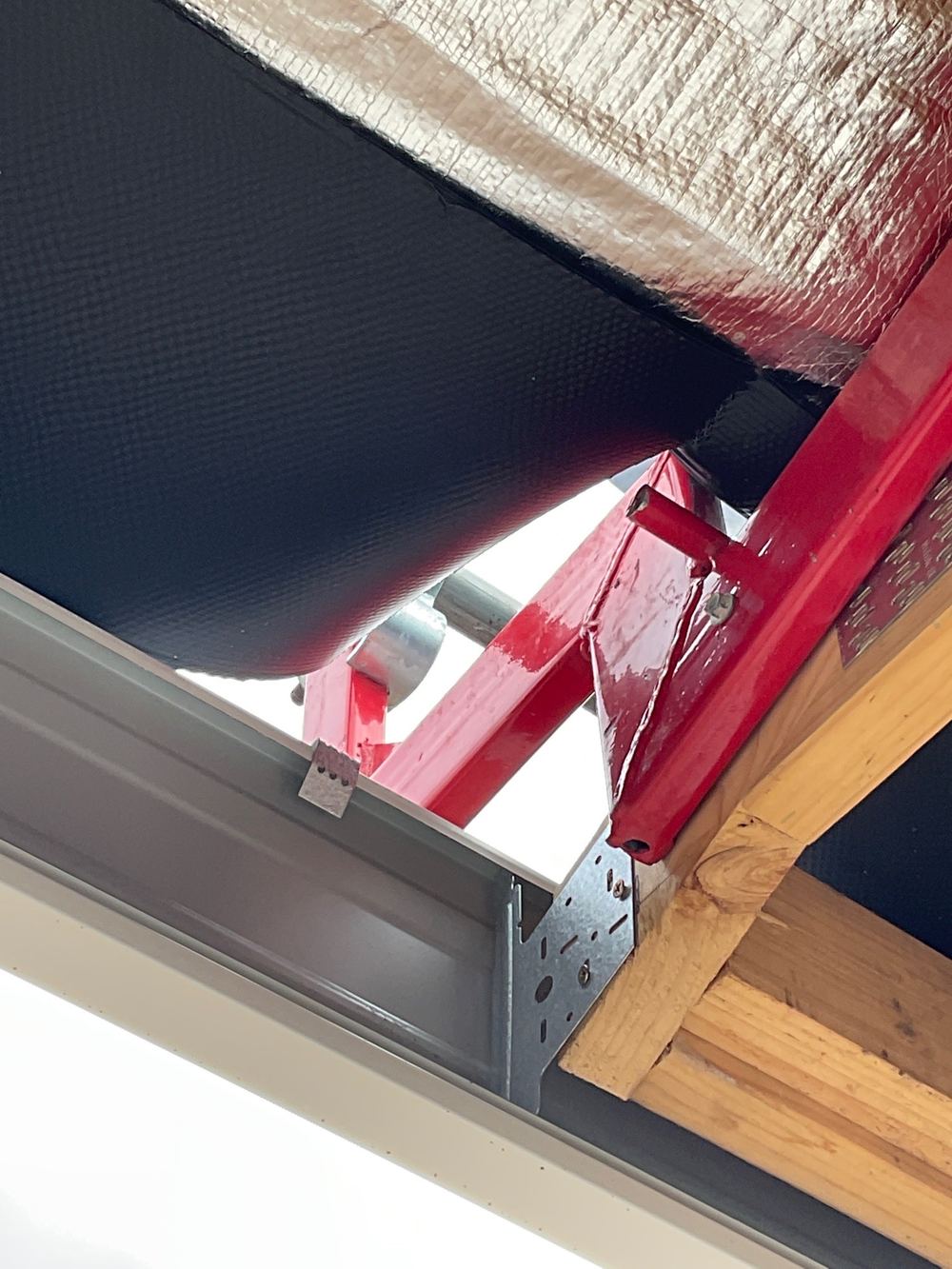 Damaged sarking and anti-ponding board at the eaves, to repair once scaffold comes down, found during a fixing inspection in Mambourin