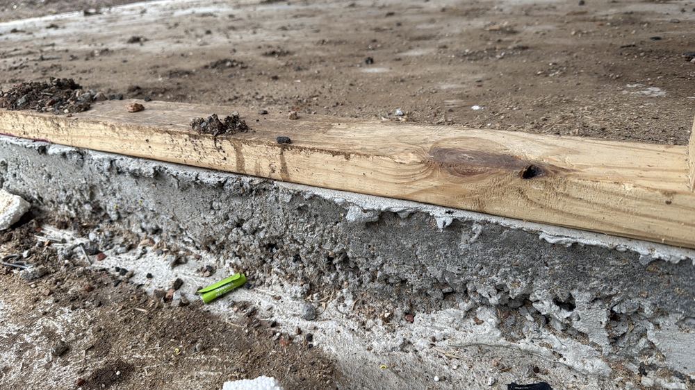 Voids in the slab edge concrete that need assessing for depth and repair, found during a frame inspection in Mambourin