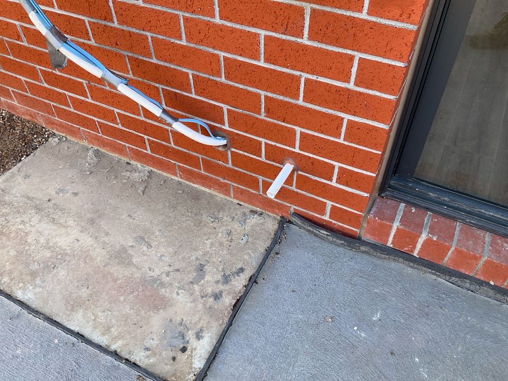 Air conditioner condensate draining onto the ground rather than to stormwater, Mambourin