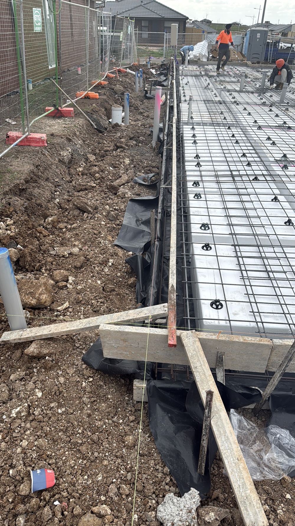 Protective caps missing from star pickets and reo bars, a fall injury hazard, found during a slab pre-pour inspection in Mambourin